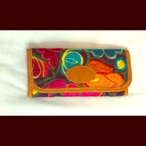Embroidered leather wallet.
